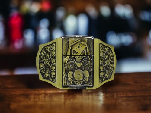 Skulls & Reaper Lighter Belt Buckle featuring intricate skull and reaper designs with an integrated brass-finish lighter.