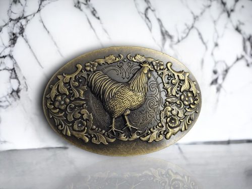 Vintage bronze oval belt buckle with a 3D rooster design, turquoise center stone, and rustic Western finish.