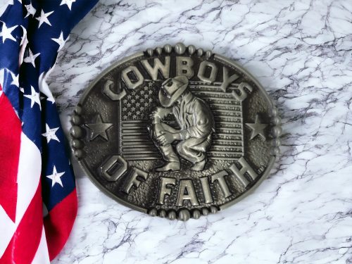 Cowboy Of Faith Kneeling in front of USA Flag Belt Buckle crafted from polished zinc alloy, featuring a patriotic oval design with a curved edge.