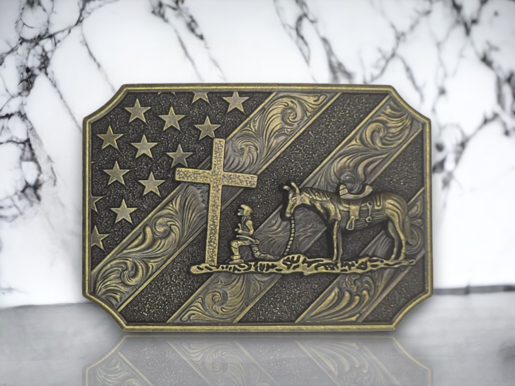 United States Flag Belt Buckle featuring a cowboy kneeling in front of a cross, crafted from polished zinc alloy.