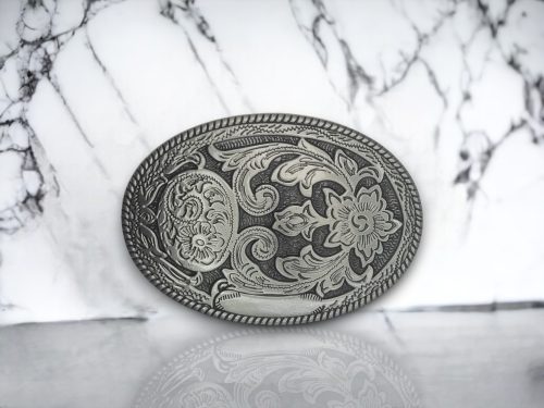 Vintage silver oval belt buckle with a brushed silver finish, perfect for cowgirl-inspired outfits.