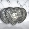 riple Heart belt buckle with a silver finish,