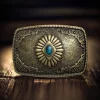 Vintage silver and bronze-plated rectangle belt buckle with a blue turquoise oval centerpiece and Southwest enamel totem design.