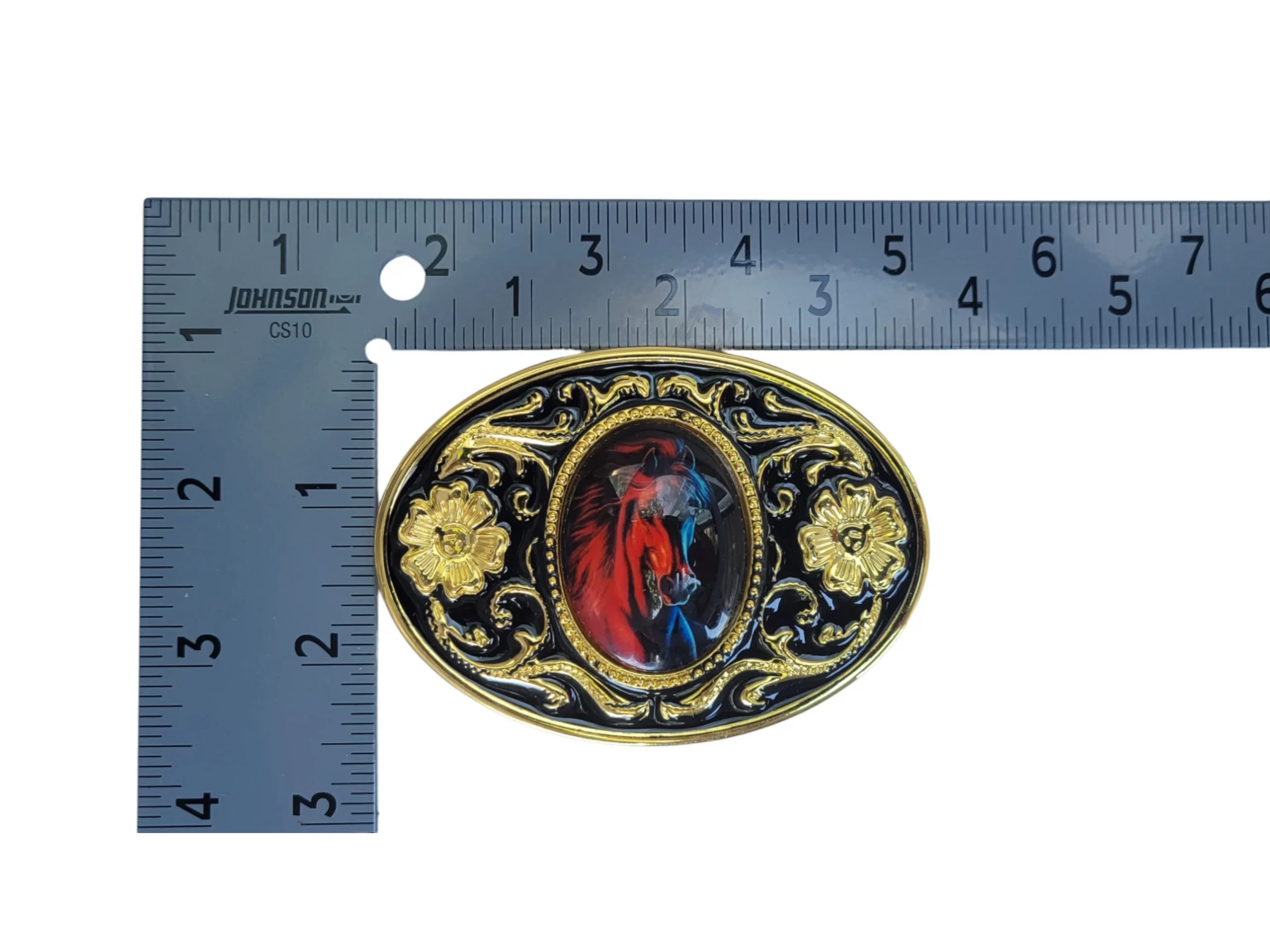 Western-style horse head belt buckle with gold and black enamel floral accents and an abalone shell centerpiece.