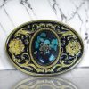 Western belt buckle with resin-protected uncut turquoise gemstone featuring a gold and black enamel floral design, crafted from durable metal alloy for a stylish look.