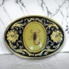 Western scorpion belt buckle with a real resin-covered scorpion, gold and black enamel floral design, and a rugged cowboy aesthetic.