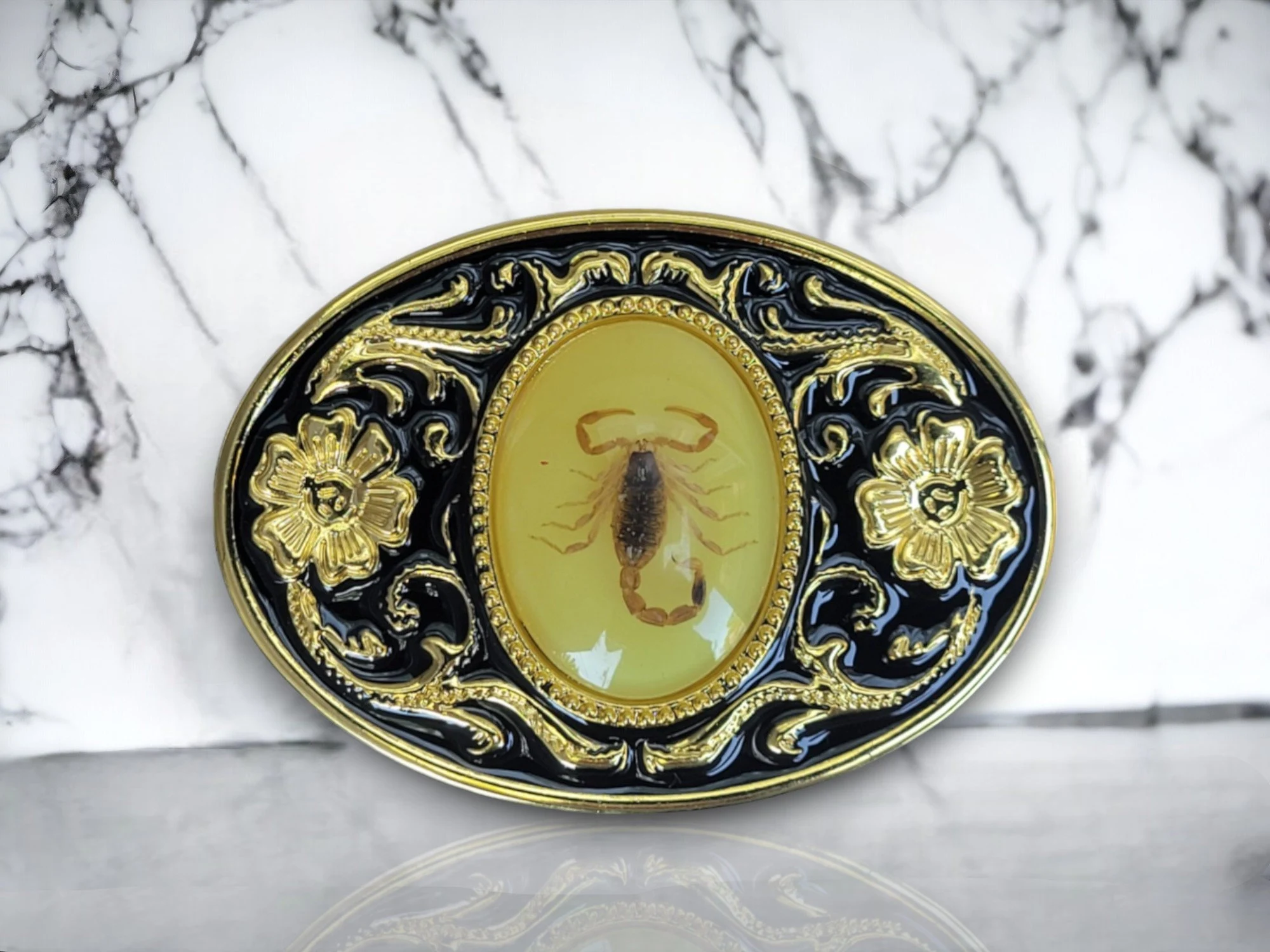 Unisex Oval Shape Black & Gold Metal Alloy Western Wear Belt Buckle With Real Scorpion (6) Western scorpion belt buckle with a real resin-covered scorpion, gold and black enamel floral design, and a rugged cowboy aesthetic.