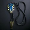 Guitar-shaped bolo tie with braided cowhide leather cord, metal tips, and adjustable slider clasp.