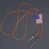 Western-style bolo tie with American flag design, braided leather cord, and metal tips.