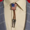 Western-style bolo tie with American flag design, braided leather cord, and metal tips.