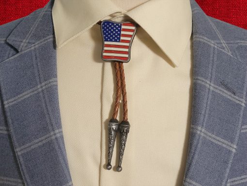 Western-style bolo tie with American flag design, braided leather cord, and metal tips.