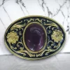 Western belt buckle with amethyst color gem featuring a gold and black enamel floral design, crafted from durable metal alloy for a stylish Western look.