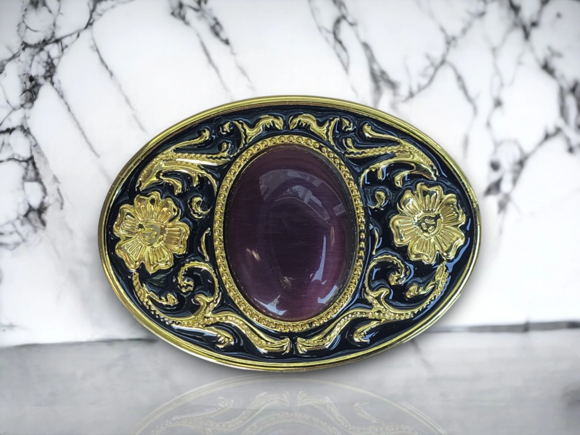 Western belt buckle with amethyst color gem featuring a gold and black enamel floral design, crafted from durable metal alloy for a stylish Western look.