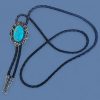 Western bolo tie with turquoise gemstone and vintage oval metal frame on braided leather cord